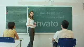 Young Female Teacher Writing on Chalkboard in Class | Stock Footage - Envato elements