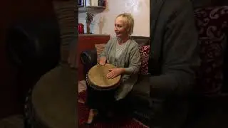 SHELLEY DARK TRAVEL Helen plays jmbe drum